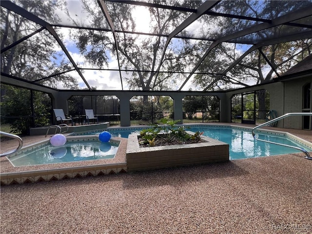 view of swimming pool with glass enclosure, a patio, and a hot tub