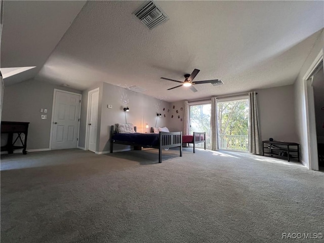 bedroom with a textured ceiling, carpet floors, vaulted ceiling, and ceiling fan