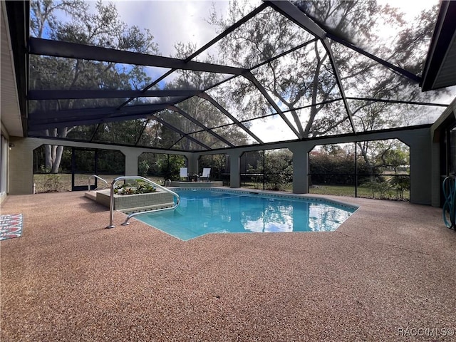 view of swimming pool with a lanai and a patio area