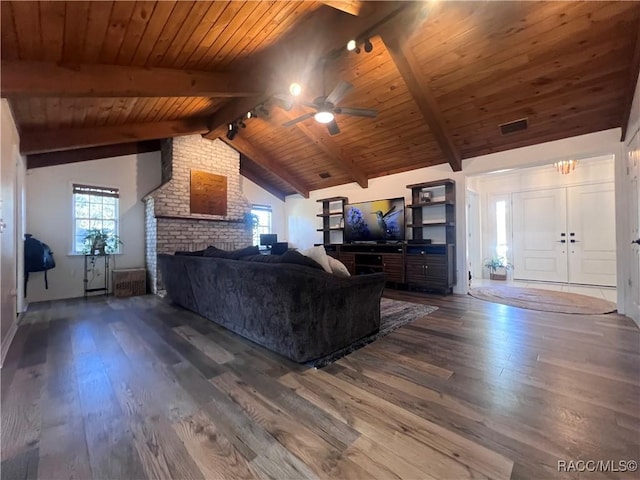 living room with a healthy amount of sunlight, vaulted ceiling with beams, dark hardwood / wood-style flooring, and wooden ceiling