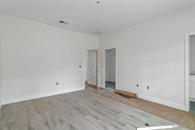 empty room with light hardwood / wood-style flooring