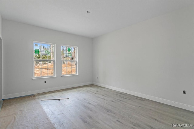 spare room featuring light hardwood / wood-style floors