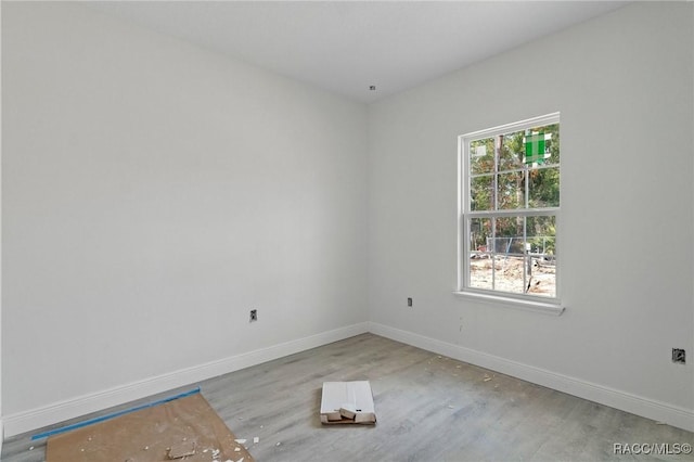 unfurnished room with light wood-type flooring