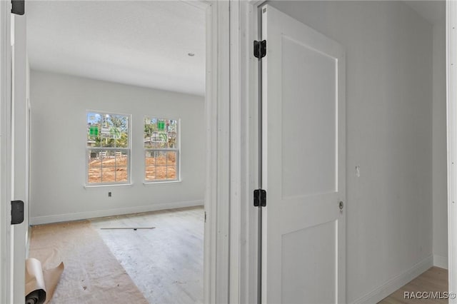 spare room featuring hardwood / wood-style flooring and a healthy amount of sunlight