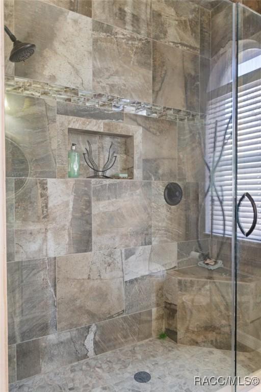 bathroom with a tile shower