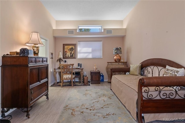 bedroom featuring light wood-style floors and visible vents