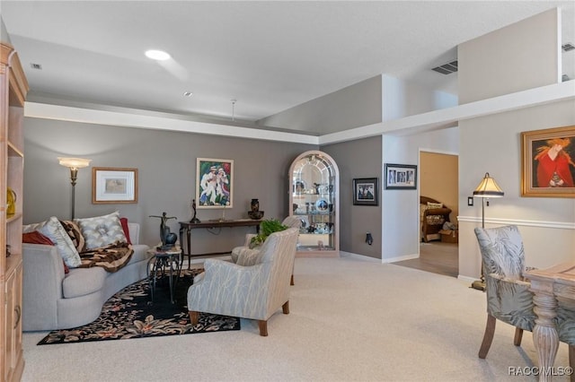 carpeted living room with baseboards, visible vents, and recessed lighting