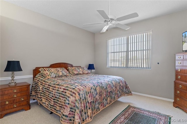 bedroom with carpet floors, baseboards, and a ceiling fan