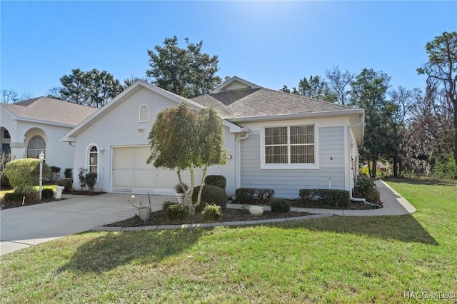 view of front of home with an attached garage, driveway, a front lawn, and roof with shingles