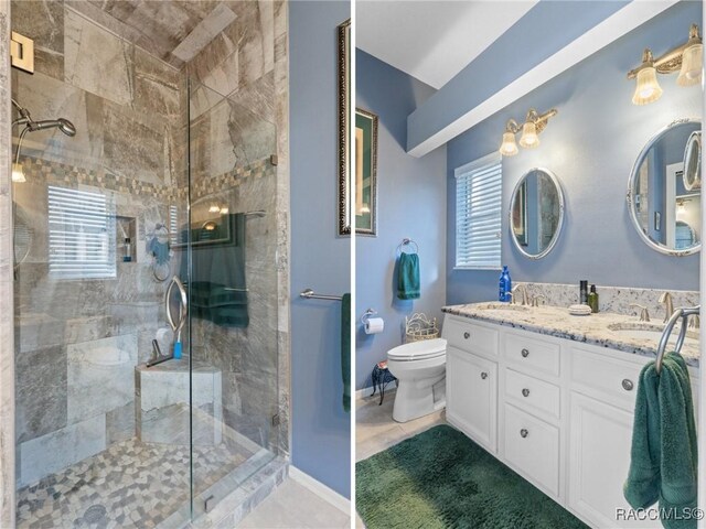 bathroom with tiled shower, a sink, and toilet