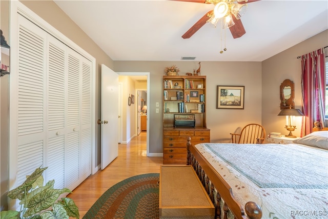 bedroom featuring ceiling fan, a closet, and light wood-type flooring