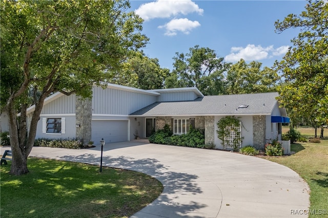 view of front of house with a front lawn and a garage