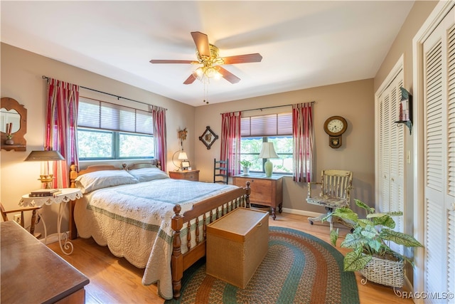 bedroom featuring multiple windows, ceiling fan, and wood-type flooring