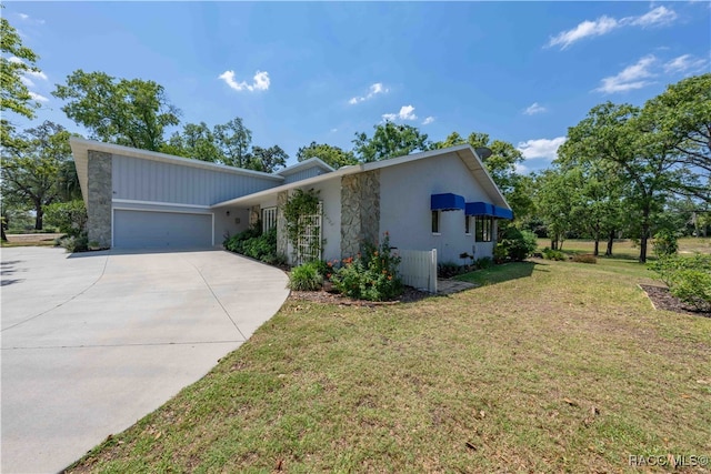 view of front of house with a garage and a front lawn