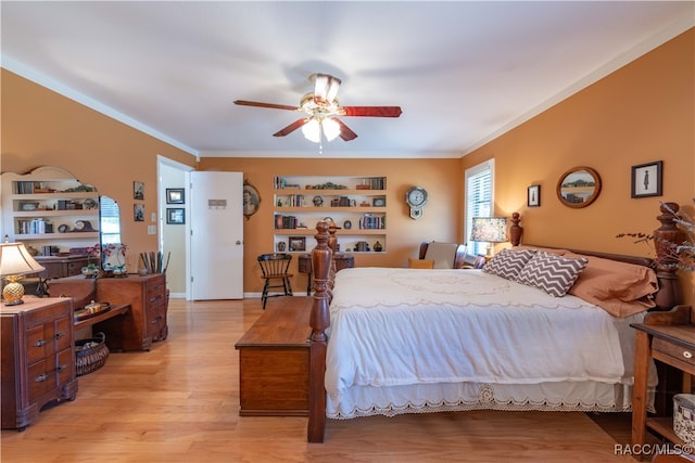 bedroom with ceiling fan, light wood-type flooring, and crown molding