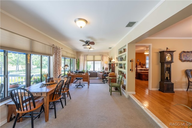 dining room featuring ceiling fan, light hardwood / wood-style flooring, and crown molding