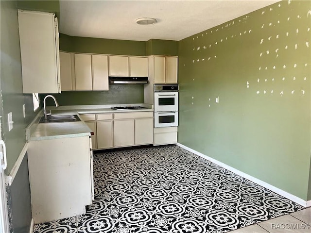 1029 NE 24th St, Ocala, FL 34470 - kitchen with a sink, baseboards, double oven, and stovetop