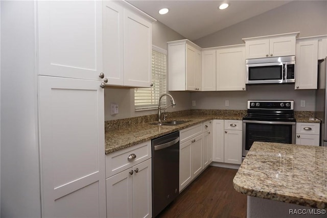 kitchen with white cabinetry, sink, stainless steel appliances, light stone countertops, and dark wood-type flooring