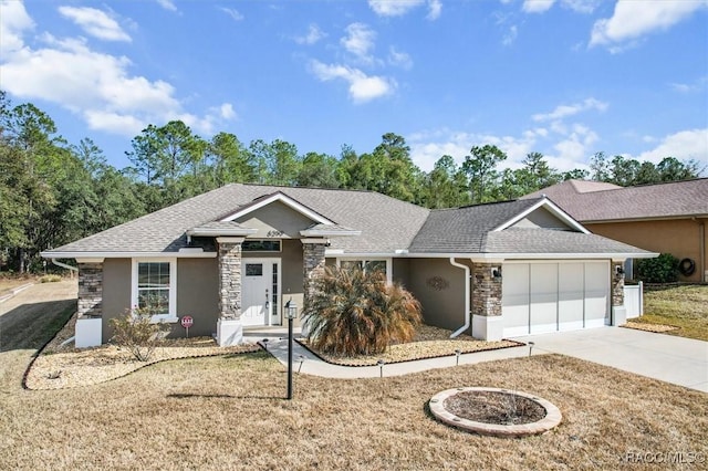 ranch-style home featuring a garage and a front lawn