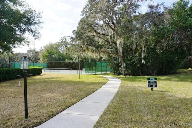 surrounding community with a lawn and tennis court