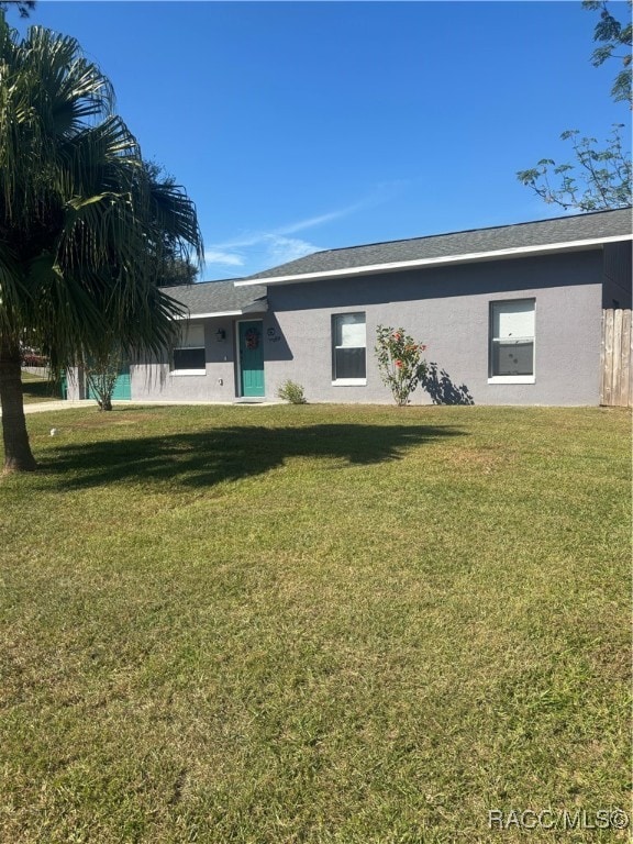 rear view of property featuring a yard