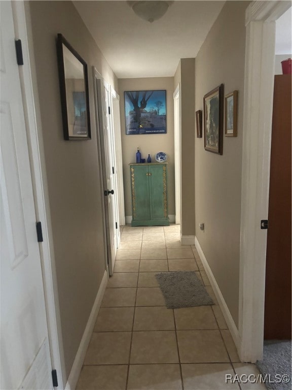 hallway featuring light tile patterned flooring