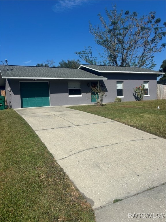 single story home featuring a front lawn and a garage