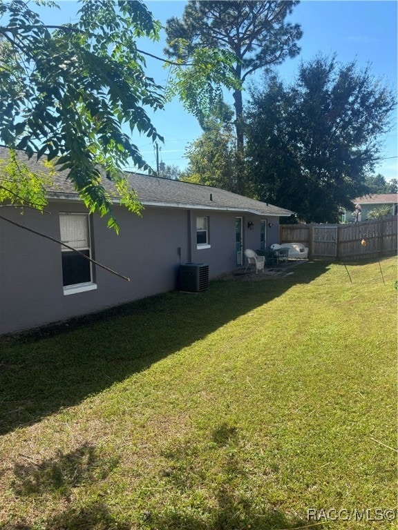 view of yard featuring central air condition unit