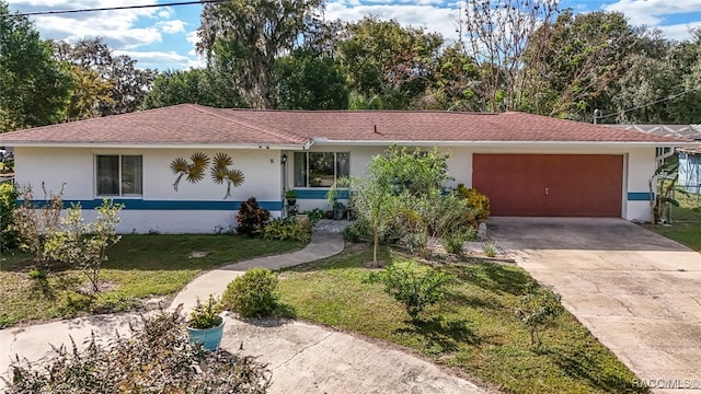 single story home featuring a front yard and a garage