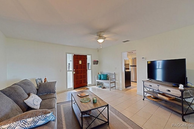 tiled living room with ceiling fan