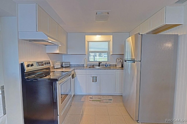 kitchen featuring light tile patterned floors, appliances with stainless steel finishes, sink, and white cabinets