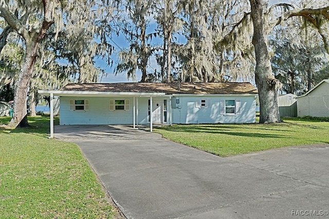 single story home with a front yard and a carport