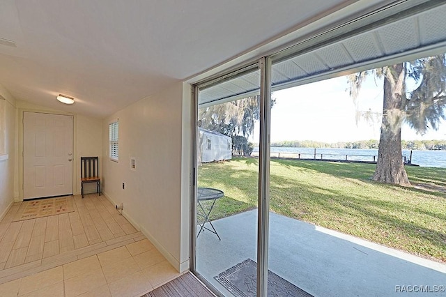 doorway featuring light tile patterned flooring and a water view