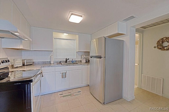 kitchen featuring white cabinetry, appliances with stainless steel finishes, sink, and light tile patterned floors