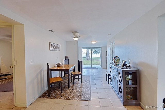 tiled dining space featuring ceiling fan