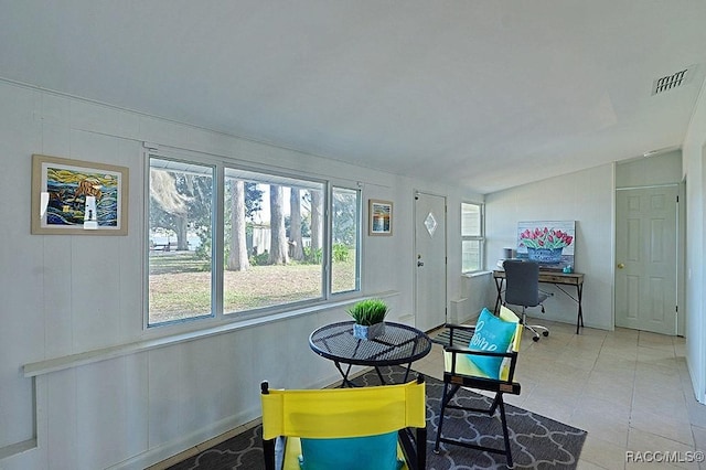 tiled dining space with vaulted ceiling