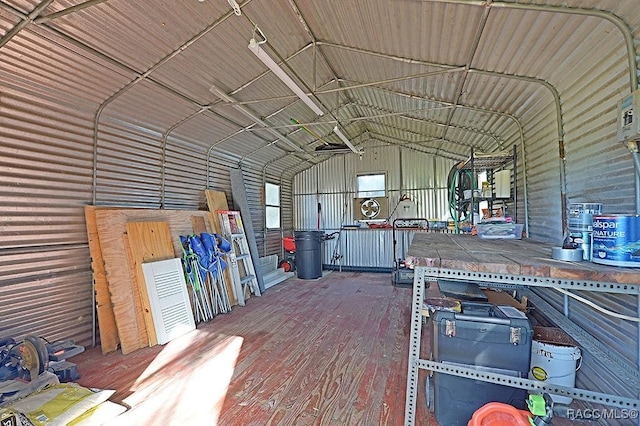 interior space with lofted ceiling and hardwood / wood-style floors