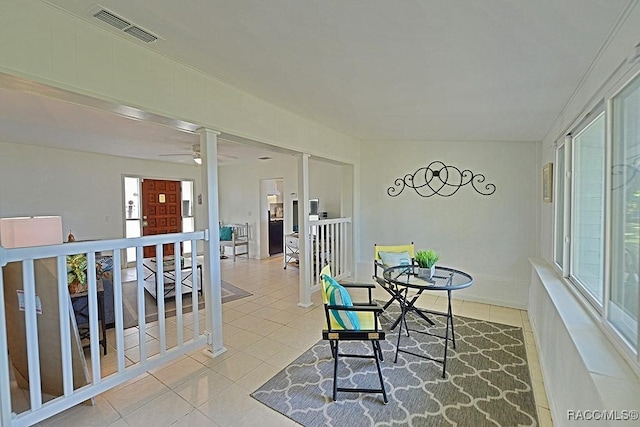 tiled dining space with ceiling fan