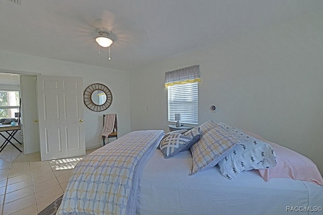 bedroom with light tile patterned floors and ceiling fan