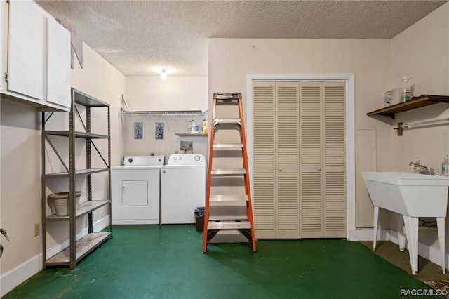 washroom featuring independent washer and dryer and a textured ceiling