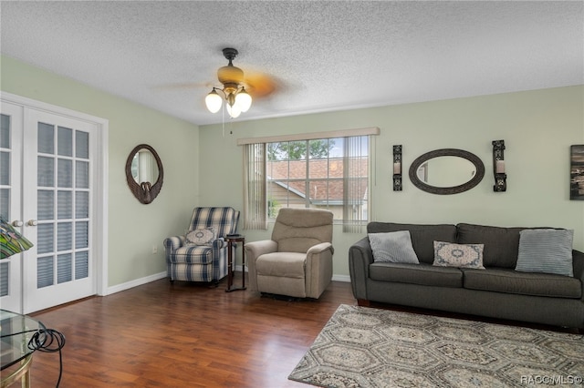 living room with french doors, a textured ceiling, dark hardwood / wood-style flooring, and ceiling fan