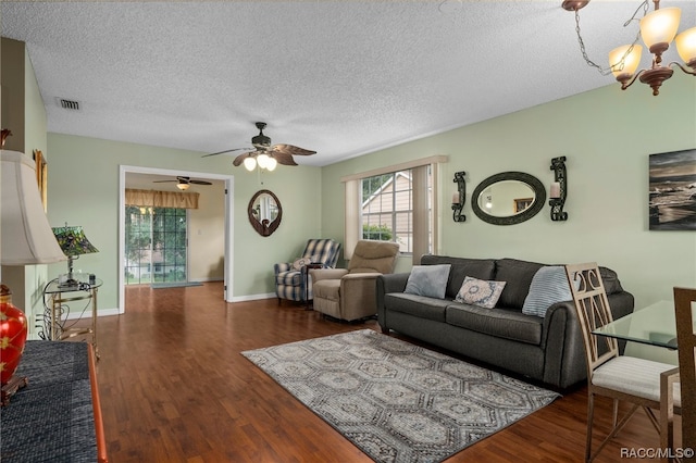 living room featuring a textured ceiling and dark hardwood / wood-style flooring