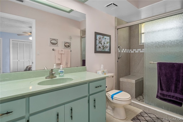 bathroom with an enclosed shower, vanity, tile patterned floors, and ceiling fan