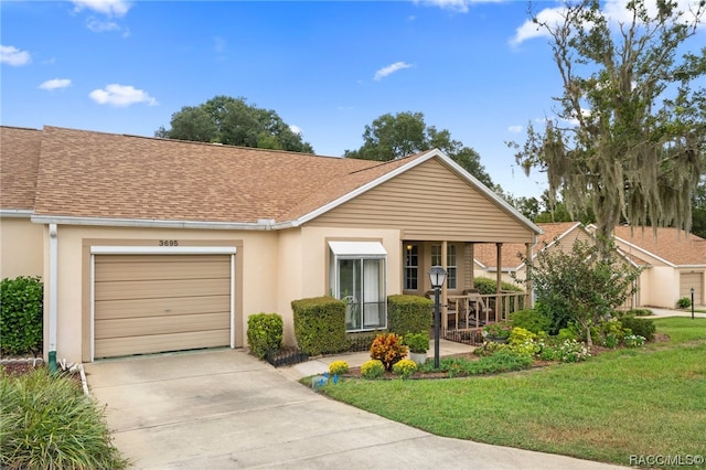 ranch-style home featuring a porch, a garage, and a front lawn