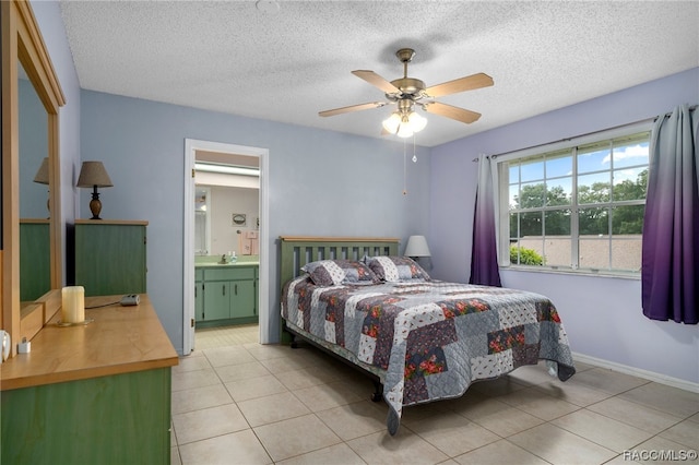 bedroom with light tile patterned floors, a textured ceiling, ensuite bath, and ceiling fan