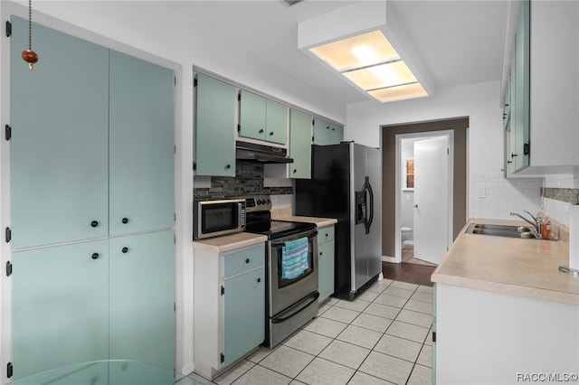 kitchen with appliances with stainless steel finishes, backsplash, and sink