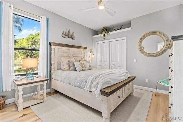 bedroom with ceiling fan, a closet, and light wood-type flooring