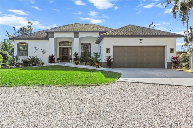 view of front of home with a garage and a front lawn