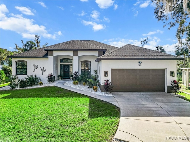 view of front of property featuring a front lawn and a garage