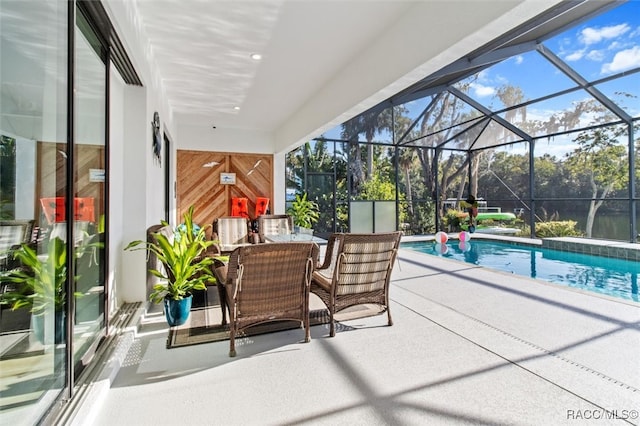 view of swimming pool with glass enclosure and a patio